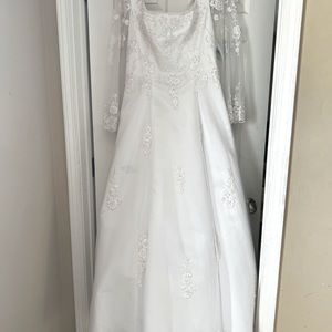 White never worn wedding gown by Victoria Bridal.